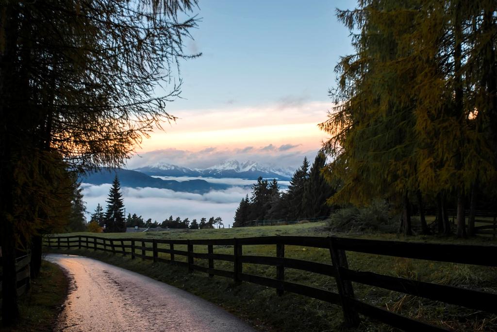 Open road leading to mountain adventure for budget travelers